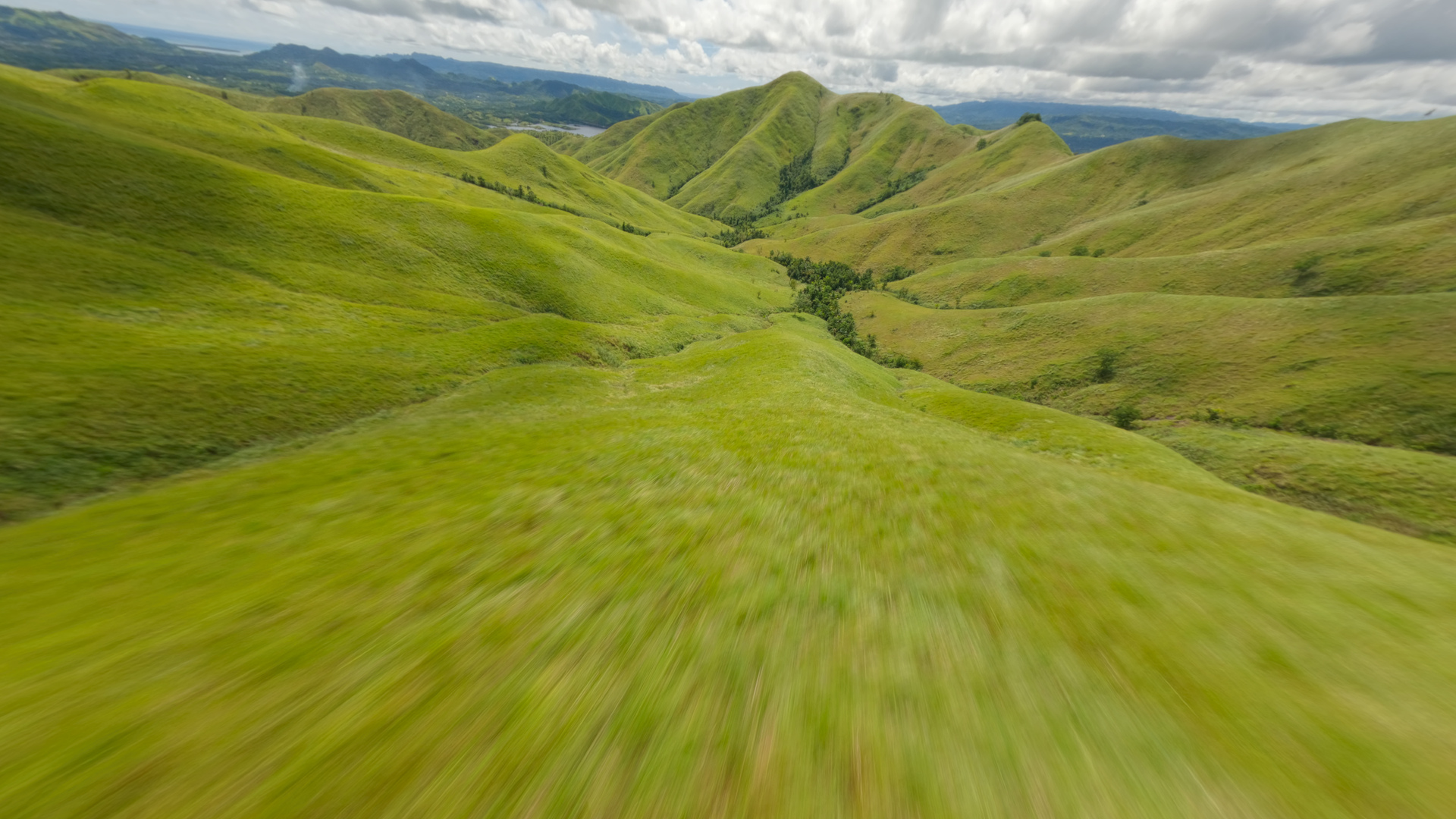 Green hills before color grading